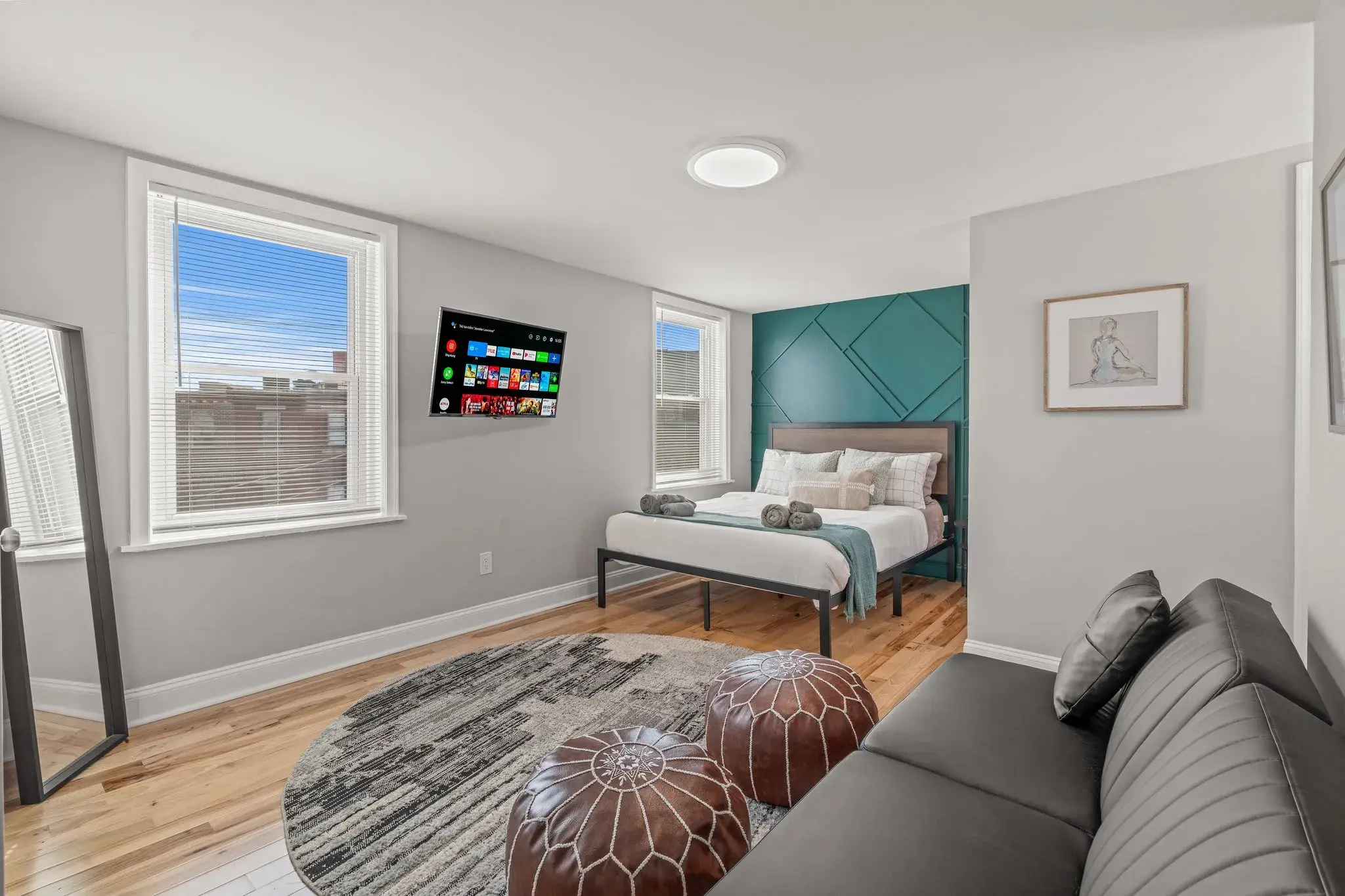 Relax in this airy bedroom with queen bed, smart TV, and seating area for an extra-comfy stay.