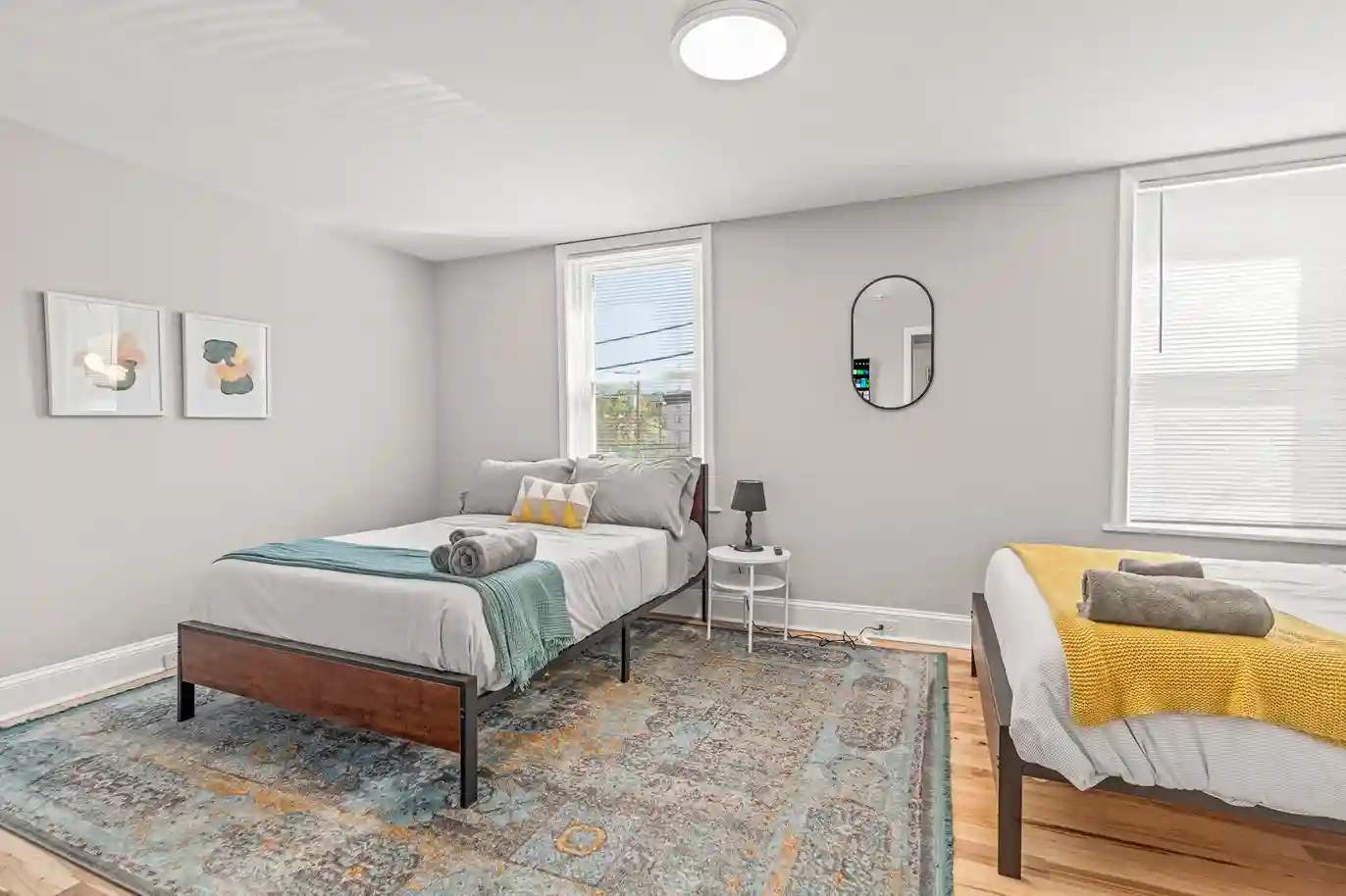 Bright bedroom with two comfy beds, fresh linens, and plenty of natural light—great for groups or families.
