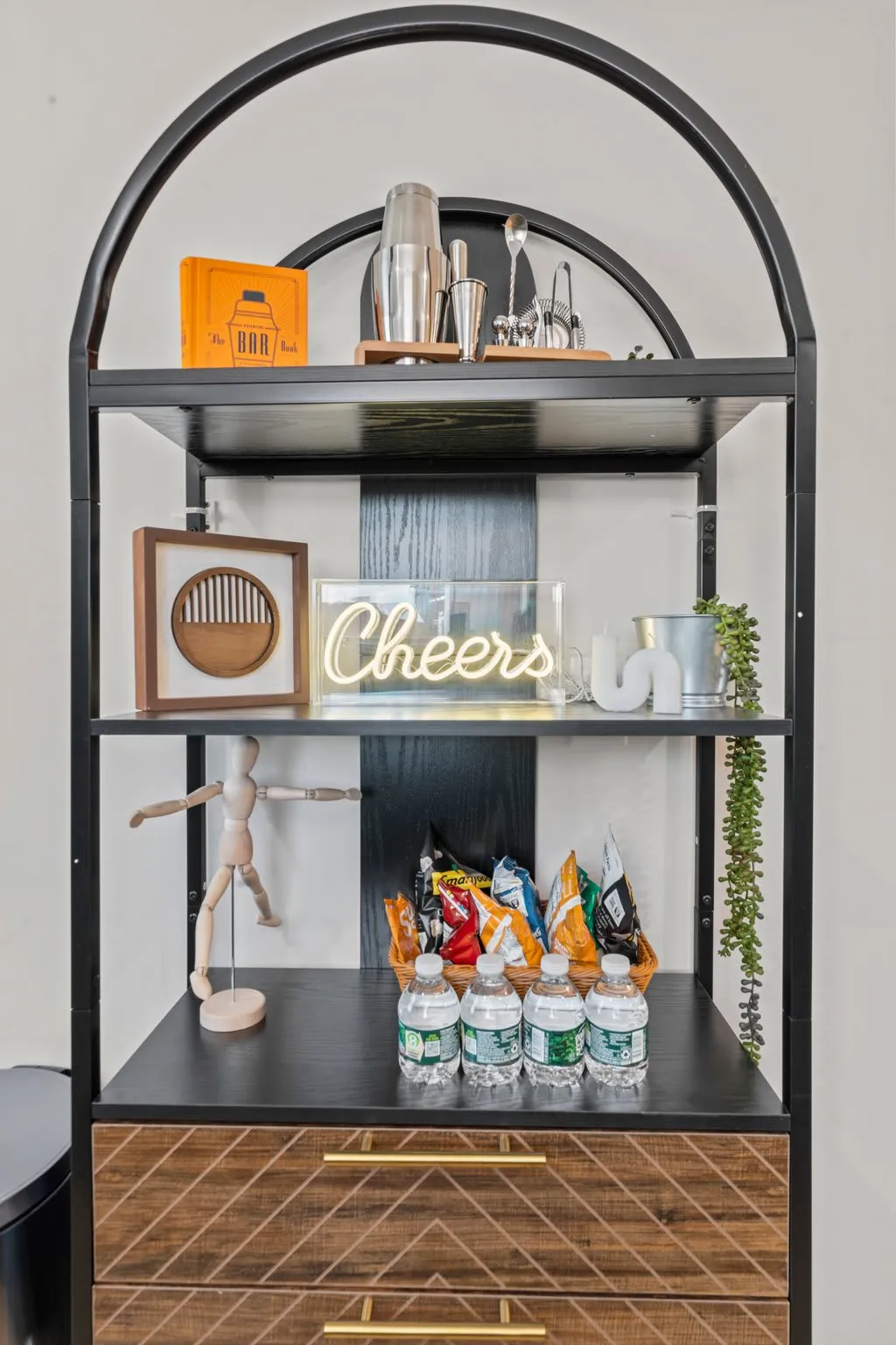 Enjoy a warm welcome—snacks, drinks, and a cheerful “cheers” bar shelf waiting to greet you.