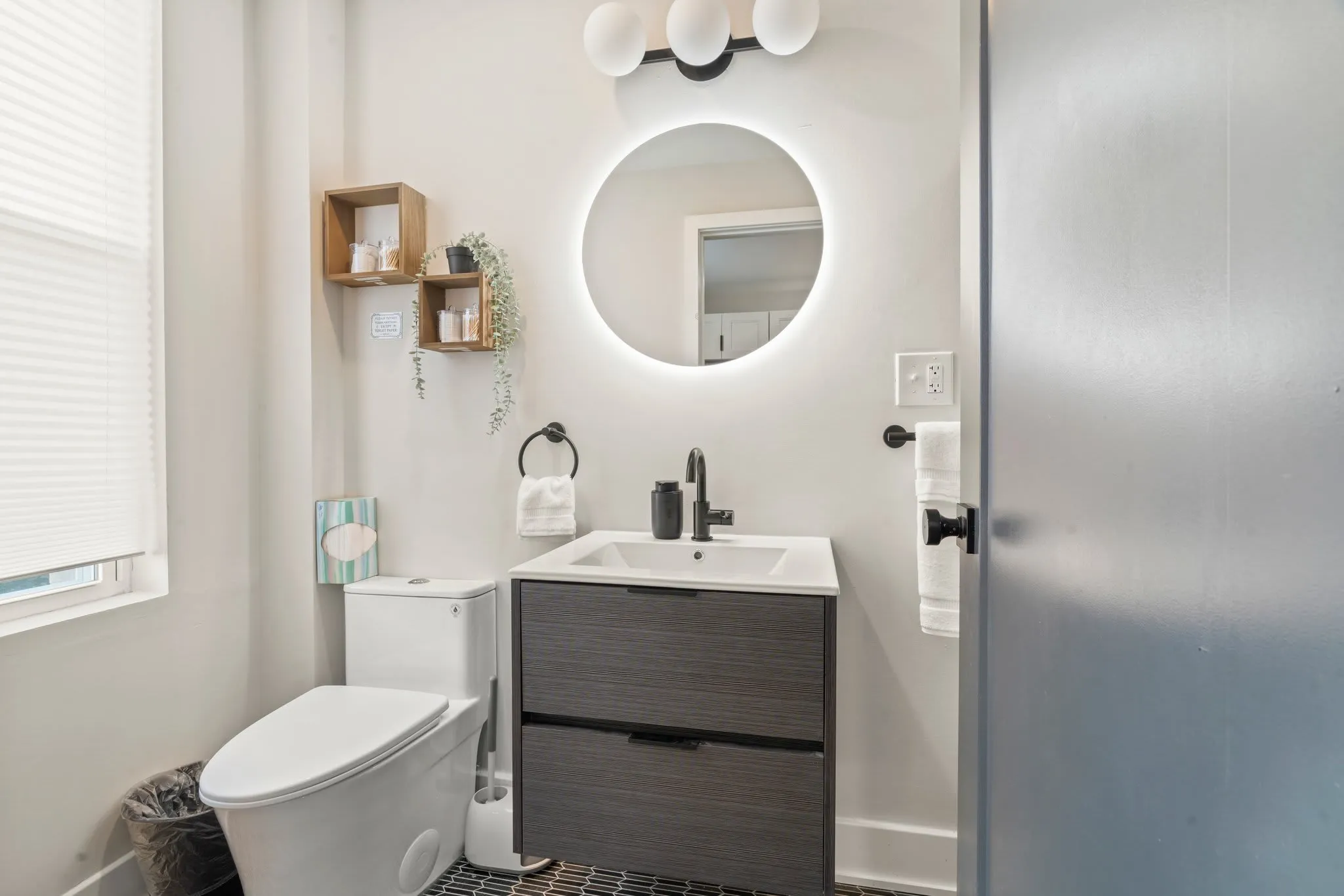 Sparkling clean and beautiful bathroom with stylish black fixtures, LED mirror and floating vanity!