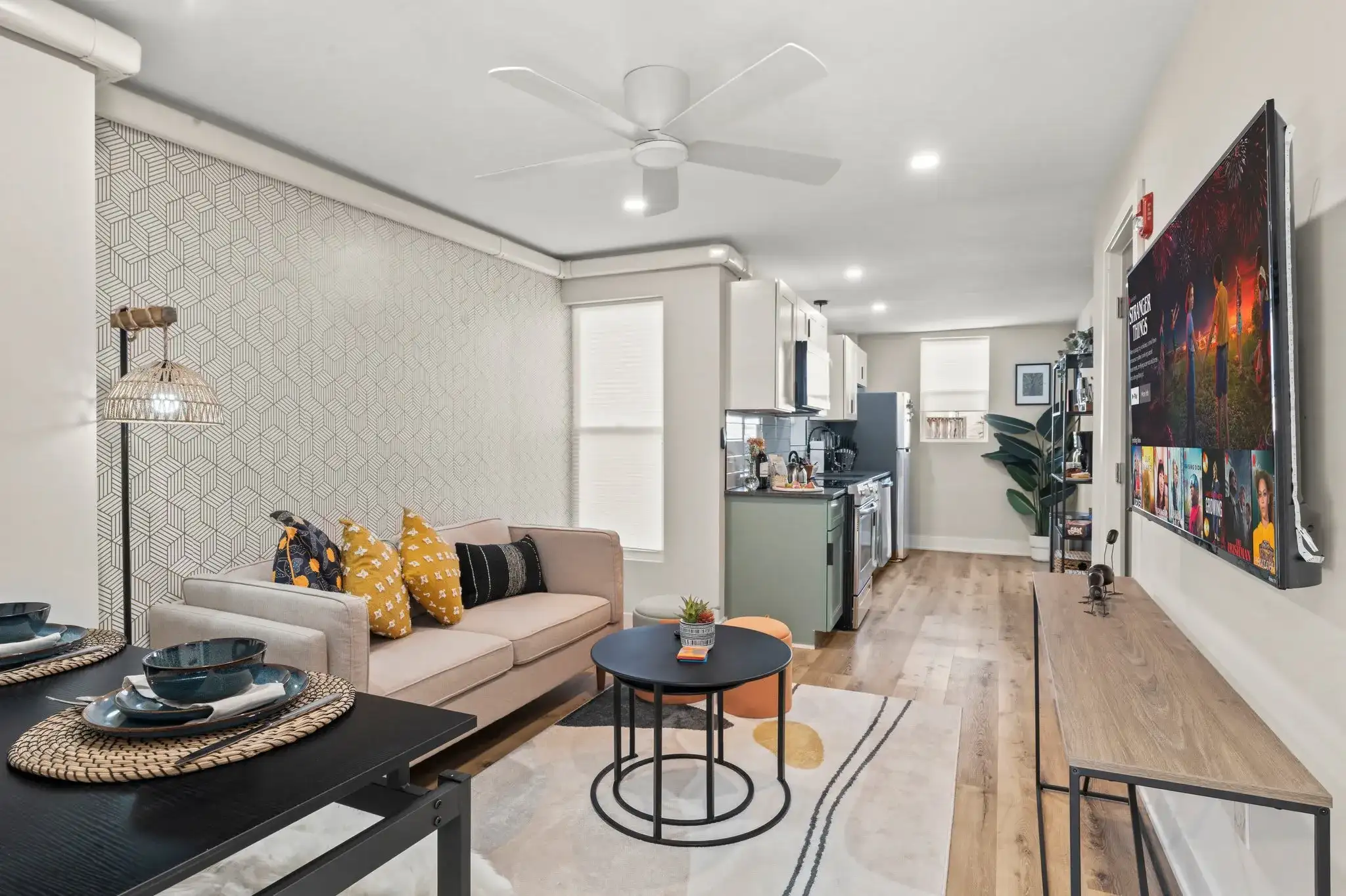 Open-concept living with designer touches, smart TV, and cozy textures—perfect for relaxing nights in.