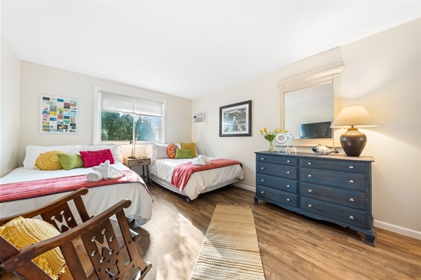 Wake up to sunshine and soft coastal air in this cheerful twin room—Netflix nights and lazy mornings included.