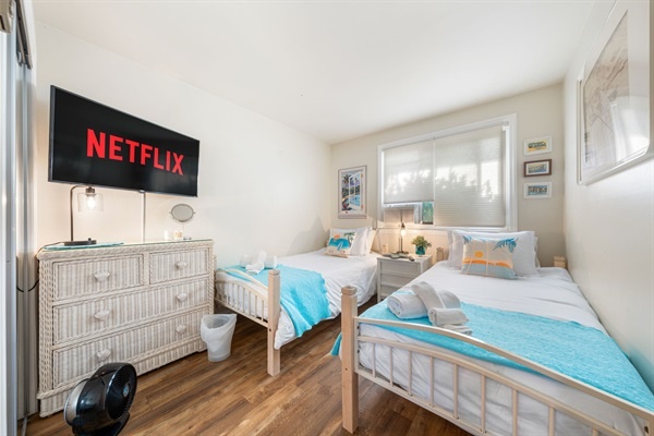 Kick back after a beach day—this twin room is cozy, fun, and Netflix-ready for a seaside movie night.