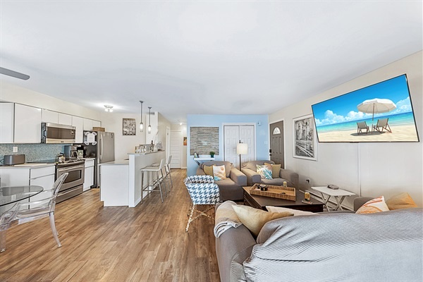An inviting open layout perfect for families and friends—modern finishes, cheerful décor, and steps to the sand.