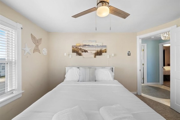 Soft coastal décor and morning light make this bedroom the perfect place to start your day by the sea.