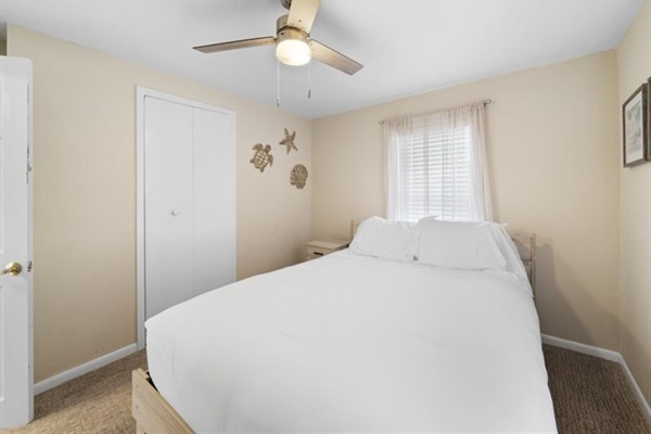 Simple, serene, and sunlit—this guest bedroom offers breezy comfort and soft coastal touches.