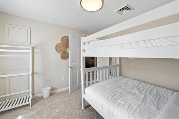 Light-filled and playful, this bunk room keeps the beach vibes going all night long.