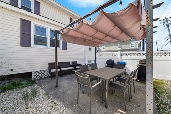 Gather for alfresco meals or sunset cocktails in this fenced patio made for connection and relaxation.