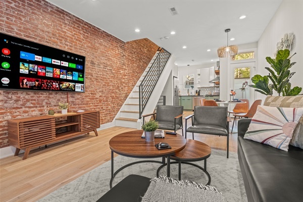 Stream your favorites on the smart TV surrounded by exposed brick and mid-century style.