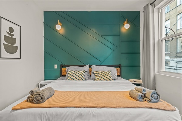 Bright and bold, this primary suite blends rich color and natural light for a calming, contemporary stay.