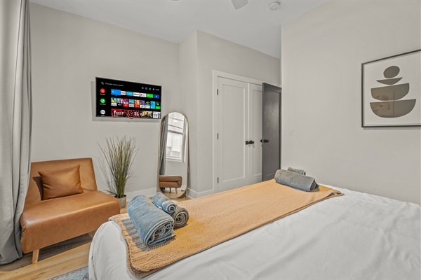 Relax in style with a cozy reading chair, full-length mirror, and Smart TV for streaming your favorite shows.