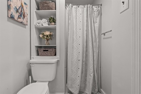 Enjoy the well-organized bathroom with ample storage and a refreshing shower. You will love the thoughtful details and stylish design that enhance your overall experience.