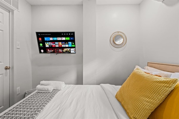 Enjoy a restful night's sleep in this inviting bedroom. The soft, stylish bedding, ample natural light, and soothing decor ensure you wake up refreshed and ready to explore.