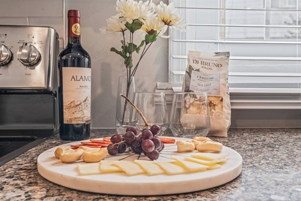 Enjoy a delightful wine and cheese platter, perfect for a cozy evening in. The elegant setup, complete with fresh flowers and gourmet snacks, will make your stay feel extra special and indulgent.