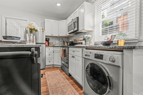 Washer & dryer on-site. Admire the bright and modern kitchen, featuring all the essentials for a comfortable stay. The compact yet efficient layout, with its stylish decor and practical amenities, is perfect for your needs.
