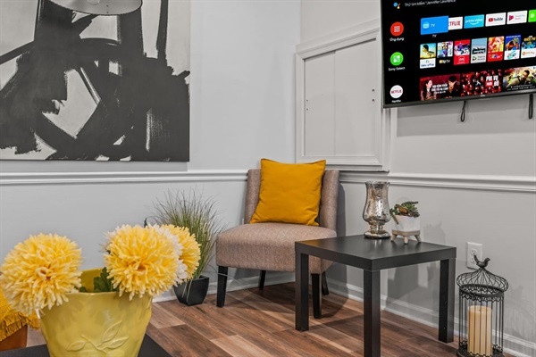 You'll love the charming details of this cozy corner! The plush chair with a pop of color, elegant decor, and thoughtful touches make this the perfect spot to enjoy a moment of peace and tranquility.