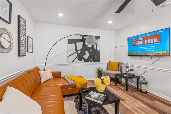 Step into a retro gaming haven with a cozy, stylish living room. You will love the blend of modern decor and nostalgic Super Mario Bros. on the big screen, making your stay both fun and relaxing.