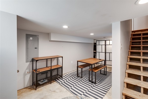 A versatile lower-level lounge—perfect for remote work, game nights, or casual meals with the crew.