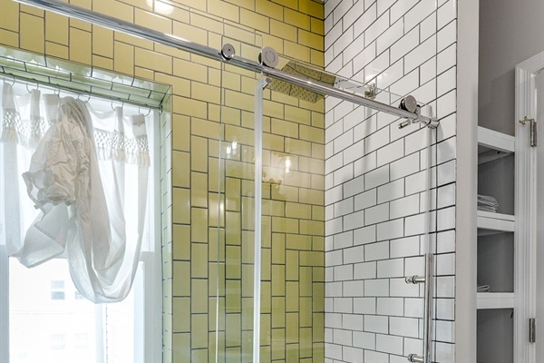 Start fresh or unwind with a hot shower surrounded by bright tile and soft towels.