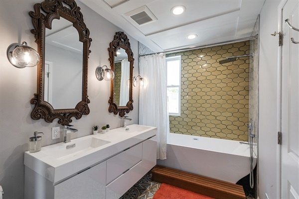 A showstopper bath with twin vanities, designer mirrors, and a spa tub—your own boutique hotel experience.