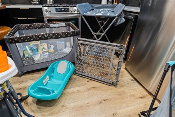 Thoughtfully equipped for families — clean, modern space complete with baby bath, gate, and play area.