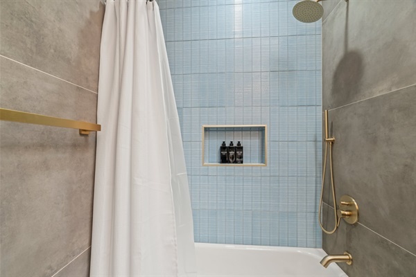 Rainfall shower luxury with designer tile and thoughtful touches — your daily refresh, redefined.