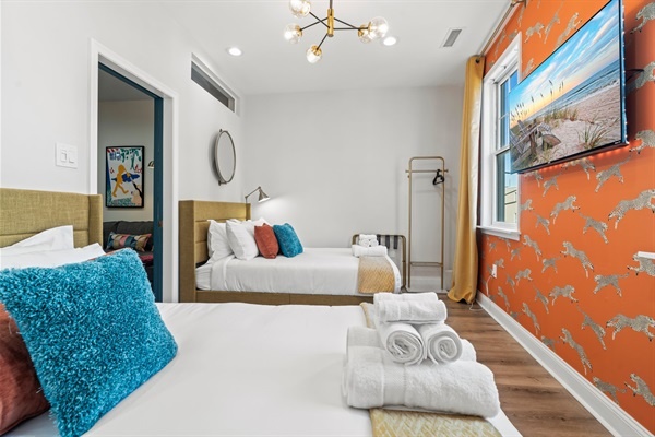 Bright and welcoming, this chic twin room is designed for rest and relaxation — complete with fresh linens and playful style.