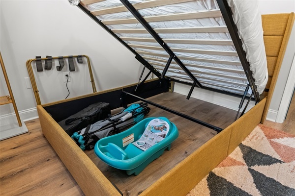 Thoughtfully equipped for families — clean, modern space complete with baby bath, gate, and play area.