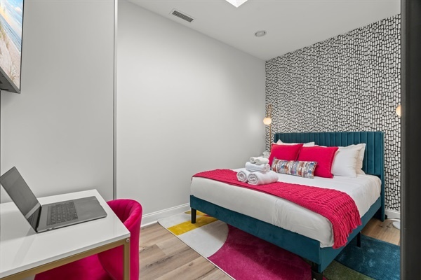 Modern and playful — this bedroom brings color and comfort together for a bold, unforgettable stay.
