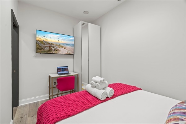 Work or stream in style — the bright pink chair and sleek workspace make productivity feel anything but ordinary.