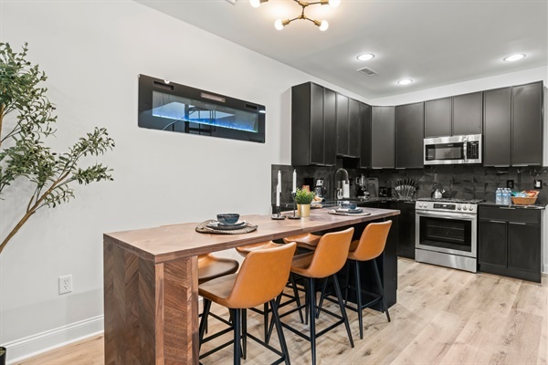 Dine with ambiance — enjoy home-cooked meals beside the glowing wall fireplace in this inviting space.