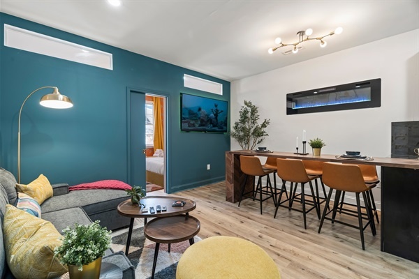 Cozy meets colorful — stretch out on the plush sectional or curl up in the mustard armchair after a day exploring Philly.