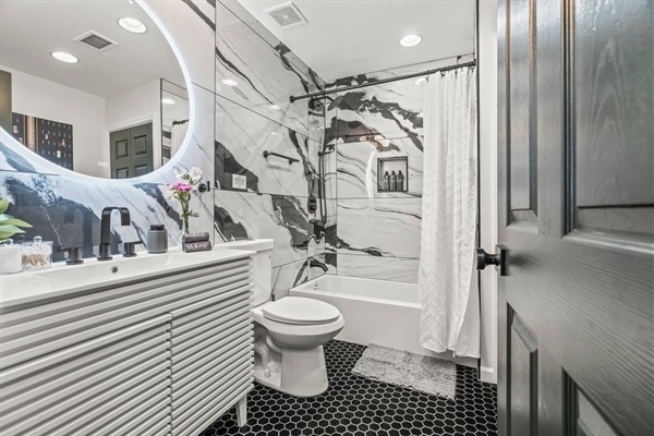 Start your day in this spa-inspired bathroom—sleek finishes, a rainfall shower, and soft lighting set the mood.