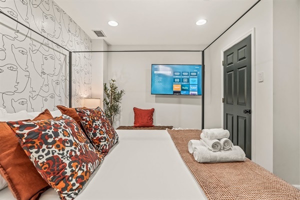 End your evening with your favorite show, cozy under crisp linens in a room that feels both chic and relaxing.