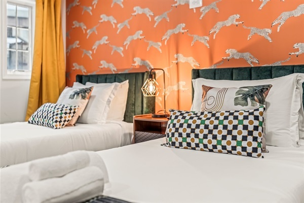 Soft bedding, bold style—this room turns every night’s rest into a boutique hotel experience.