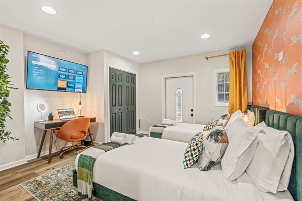 Bright, fun, and functional—this stylish twin suite doubles as a workspace and cozy retreat.