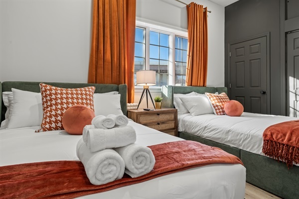 Wake up refreshed in this inviting retreat, where bold colors meet plush bedding and plenty of natural light.