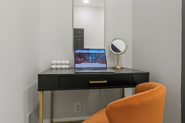 Catch up on work or plan your Philly adventures at this stylish vanity-desk setup with bright, modern charm.