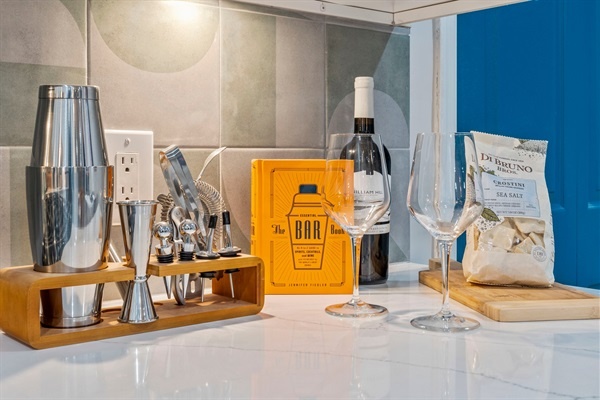 Enjoy the elegant bar setup, complete with wine glasses and cocktail tools. It’s perfect for unwinding with a drink or impressing your friends with your mixology skills.