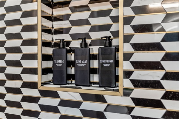 You will love the high-quality toiletries provided in the stylish bathroom. The sleek shampoo, body soap, and conditioner bottles are not only convenient but also add a touch of elegance to your shower experience.