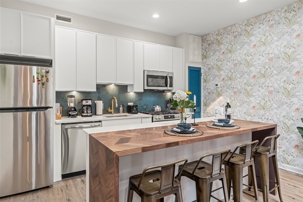 Step into a kitchen that blends modern convenience with stylish design. You will appreciate the high-end appliances, beautiful countertops, and thoughtful details that make cooking a pleasure.