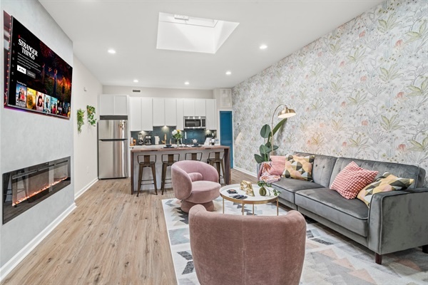 Immerse yourself in our chic living room! You will love the modern decor, cozy seating, and entertainment options. The perfect spot to unwind after a day of exploring.