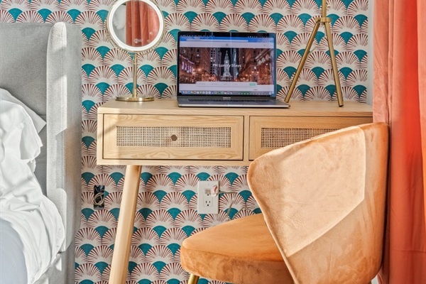 Appreciate the stylish and functional workspace, perfect for catching up on work or enjoying a good book. The chic desk and comfortable chair make this nook an ideal spot for productivity or relaxation.