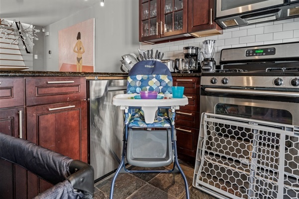 The kitchen is set up to accommodate families with children, featuring a high chair and child silverware