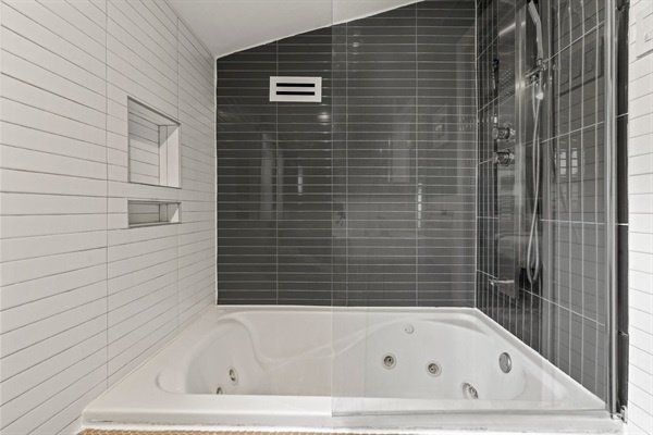Treat yourself to a relaxing soak in the jetted tub or a refreshing rinse in the elegant walk-in shower. This bathroom offers a tranquil escape after a day of exploring the city.