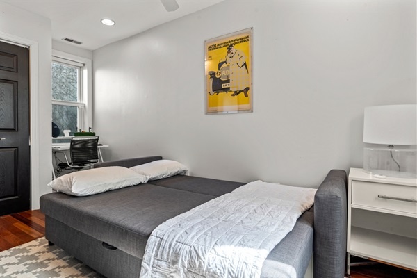 The living room's sofa easily converts into a bed, providing extra sleeping space for guests.