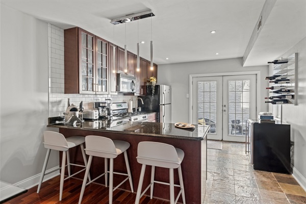 A well-equipped kitchen with stainless steel appliances and a breakfast bar is ready for your culinary adventures.