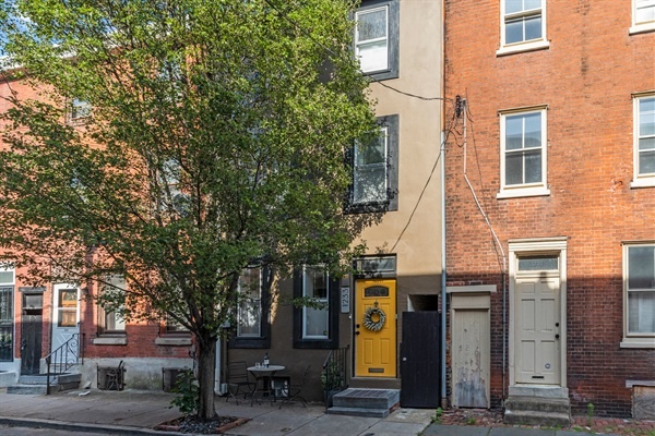 You'll fall in love with this charming townhouse featuring a vibrant yellow door. Nestled on a tree-lined street, it's the perfect blend of historic charm and modern comfort.