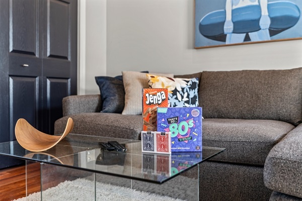 A selection of board games in the living room for fun and entertainment.
