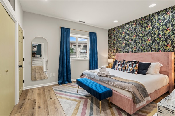 A playful mix of pattern and texture makes this bedroom both stylish and soothing — perfect for unwinding after exploring Philly.